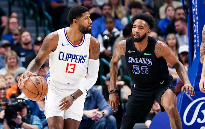 Mavs' Derrick Jones Jr. defends Clippers' Paul George in the post.